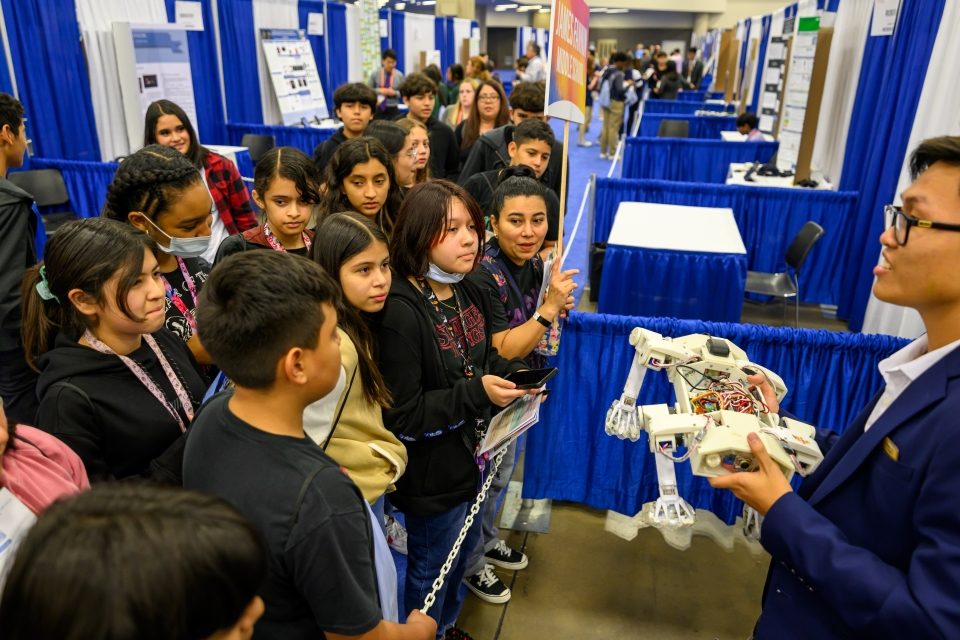 ISEF exhibit hall - students demonstrating a robotics project